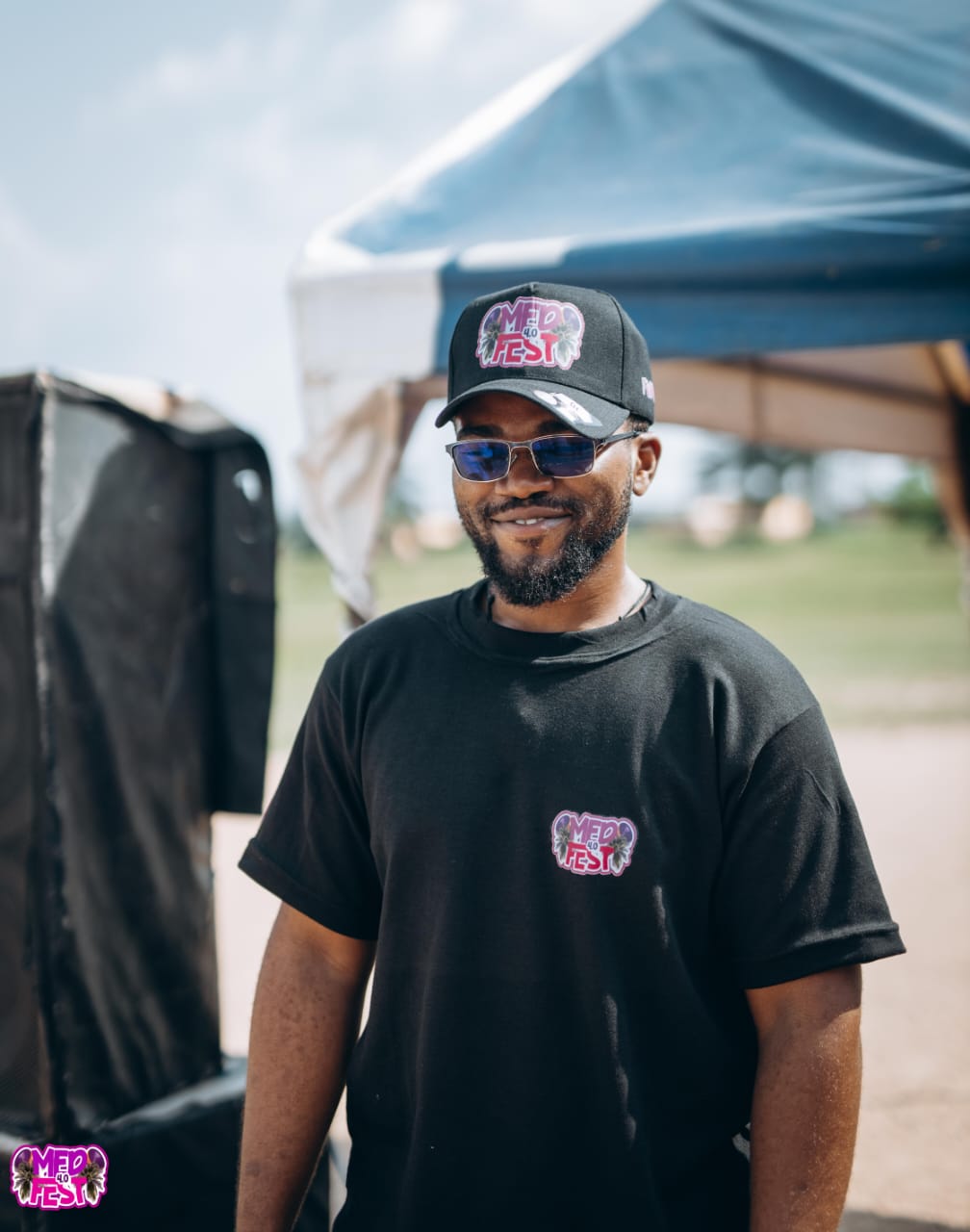 A smiling man in a black MedFest tee